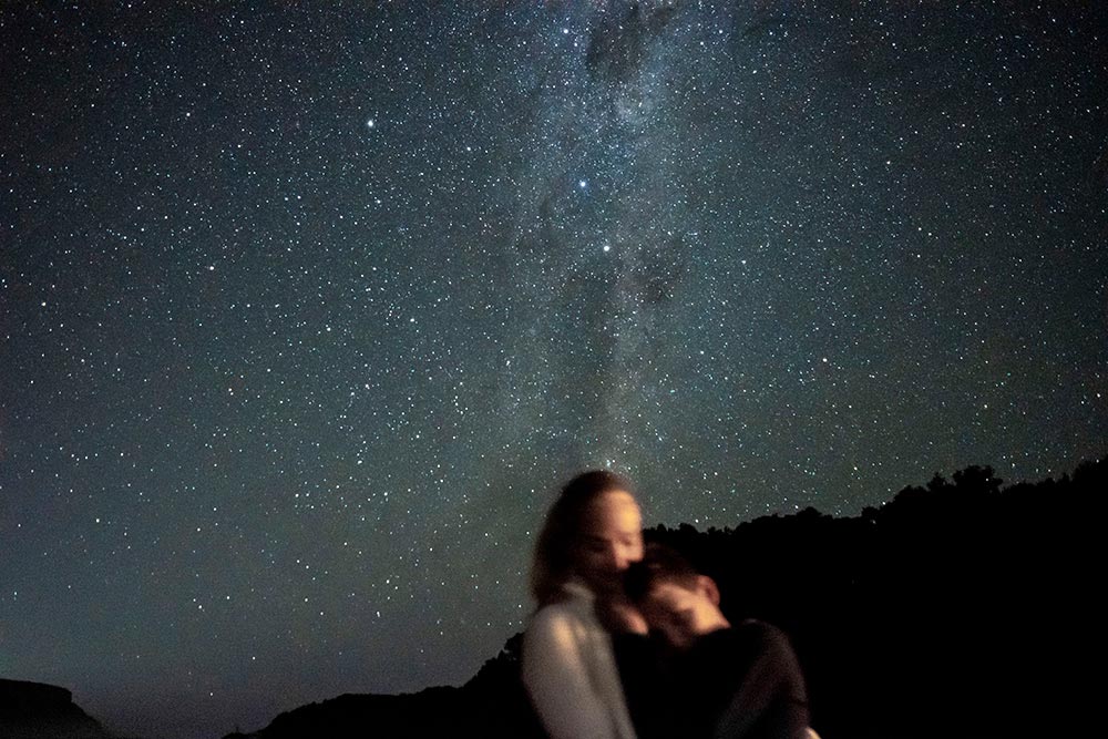 Mother and son hugging under stars in Natures Valley in South Africa