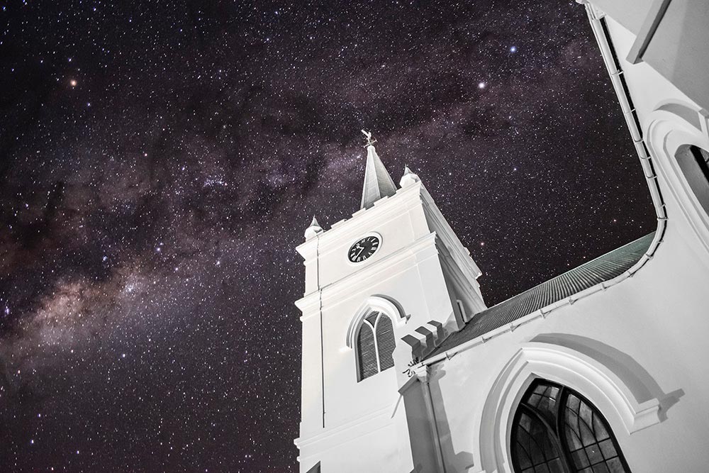 Milky way stars with white church in the foreground